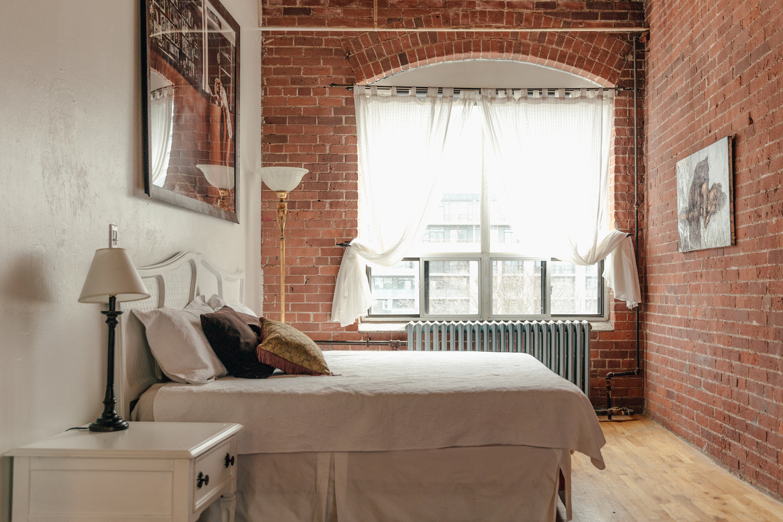 A calm, softly lit bedroom with warm bedding